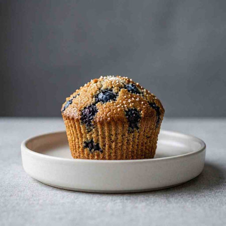 Homemade blueberry muffins with sesame seeds on a gray background