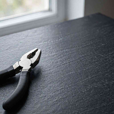 Pliers on a black background. Selective focus. Copy space.