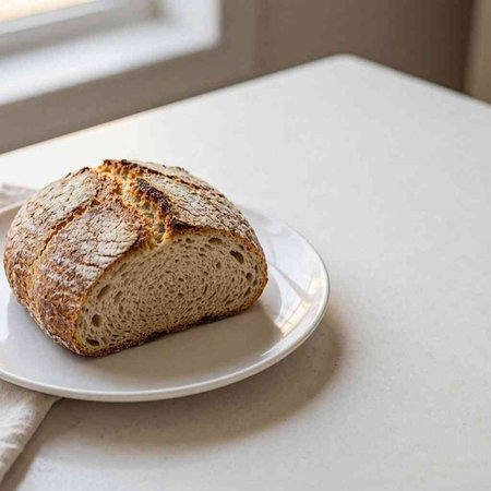 Sliced bread on a white plate on a white table.