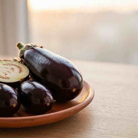 Eggplant in a ceramic plate on a wooden table. Selective focus.