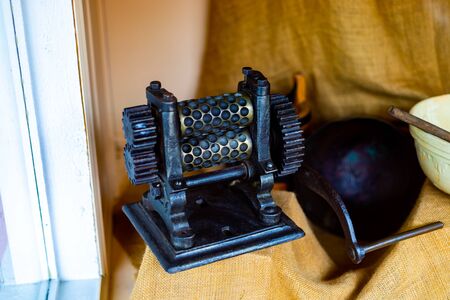 An Old Fashioned Candy Drop Roller Machine. Black and Gold Metalの写真素材