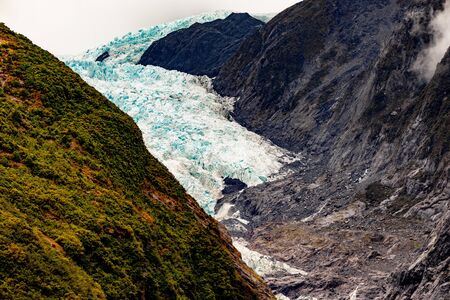 Up Close to Franz Josef Glacier. Cold Blue Ice and Rocksの写真素材