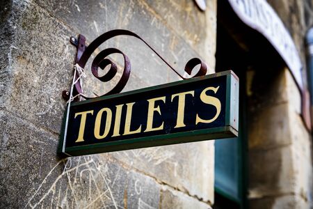 An Antique Toilet Sign Shows The Way to the Restroomの写真素材