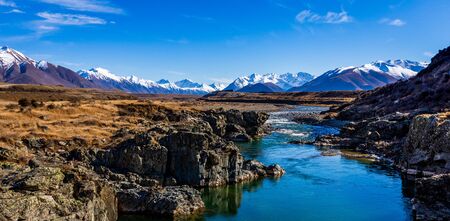 The Ahuriri River and Mountain Range on a Vibrant Spring Day in New Zealand. This Is Truly A Place Like No Other. Some Call It Paradise. Kiwis Call It Homeの写真素材