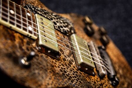 A Textured Rustic Guitar Ready For Actionの写真素材