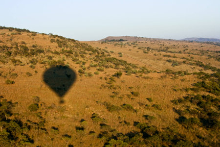 Shadow of balloon in the bush flying over the hills in africaの写真素材