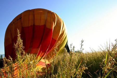 Hot Air Balloon deflating in the grassの写真素材