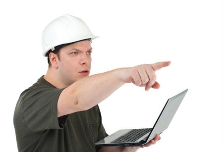 Malicious construction superintendent in a white helmet with the laptop in hands pointing on...
