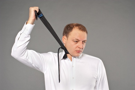 Businessman hanging himself with his necktieの写真素材