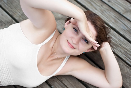 Attractive women relaxing on a pier in the sunshineの写真素材