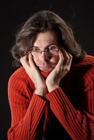 Man with log hair in red sweater and glasses.の写真素材
