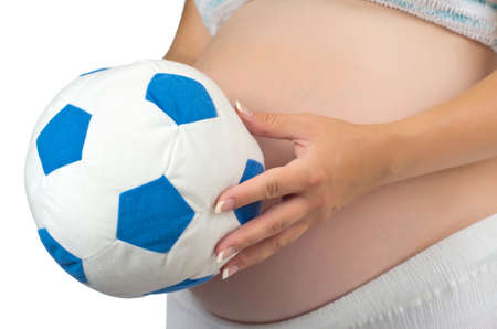 Belly of a pregnant woman with soft toy ball. Isolated on white background.の写真素材