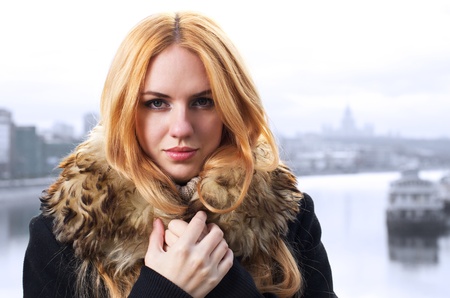 Young caucasian beautiful  redhead  woman against urban background.の写真素材