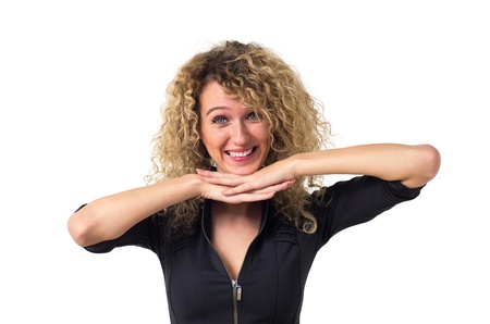 Attractive young business woman with curly hair looks over her folded hands. Isolated against white background.の写真素材