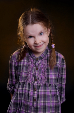 Little girl dressed in a plaid dressの写真素材