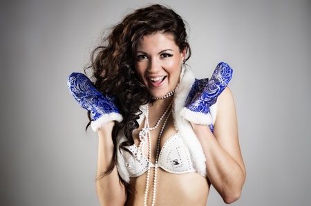 Beautiful xmas brunette snow maiden against grey backgroundの写真素材