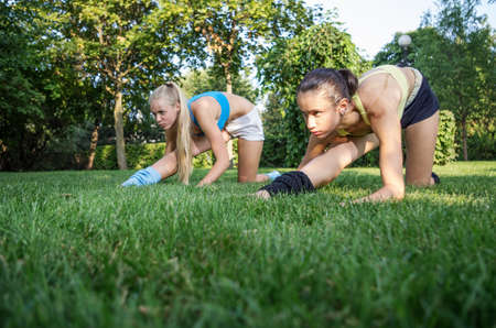 Couple young caucasian woman training in the parkの写真素材