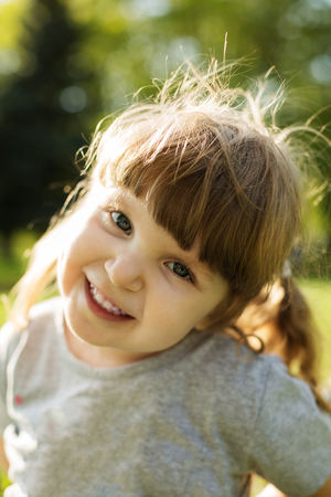 Closeup Portrait of little caucasian girl playing in the park.の写真素材