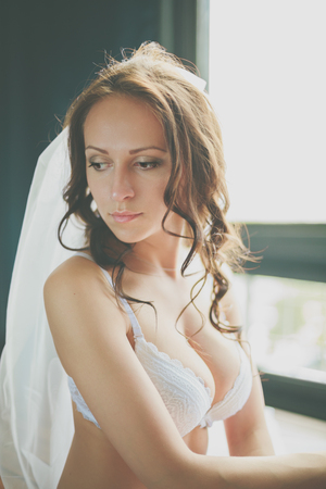Portrait of young caucasian bride in lingerieの写真素材