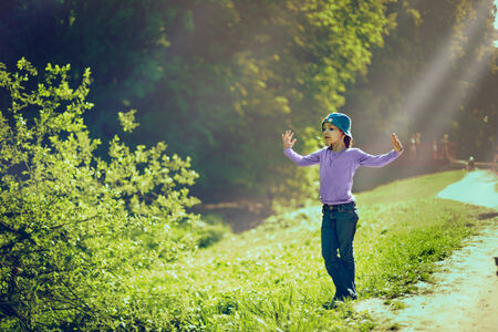 Portrait of little caucasian girl playing in the park.の写真素材
