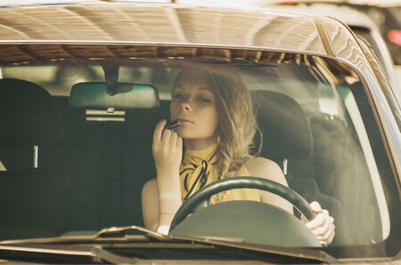 Beautiful caucasian young woman driving a carの写真素材