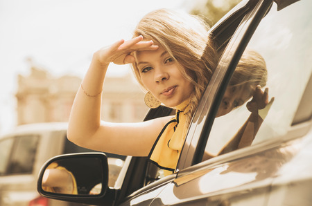 Beautiful caucasian young woman driving a carの写真素材