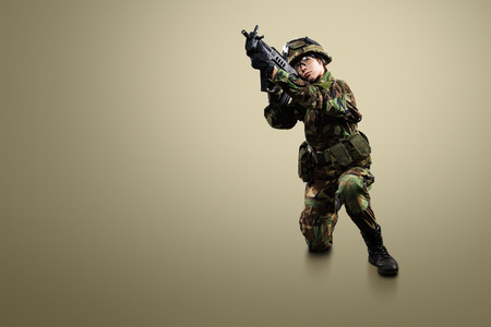 NATO soldier. Military woman over khaki background.