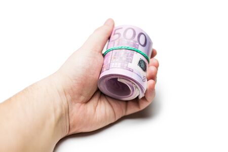 Pack of banknotes in roll. Isolated over white background.の写真素材