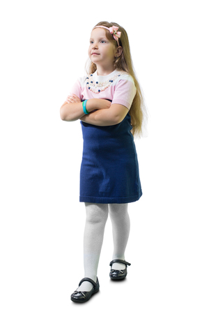 Schoolgirl in uniform crossed her arms on the chest against white background.の写真素材