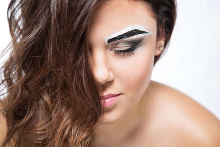 Portrait of beautiful female model on white backgroundの写真素材