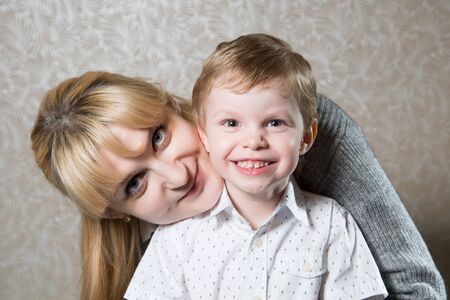 Portrait of young caucasian woman with her sonの写真素材