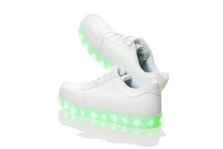 White sneackers with led light sole. Isolated over white background.の写真素材
