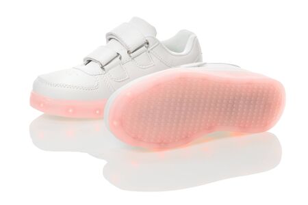 White sneackers with led light sole. Isolated over white background.の写真素材