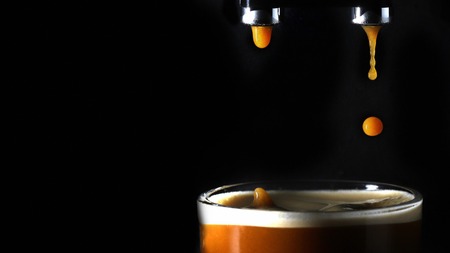 Droplet of coffee splashing in a mugの写真素材