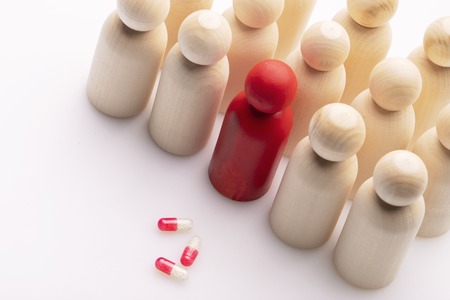 Wooden figures of people and pillsの写真素材