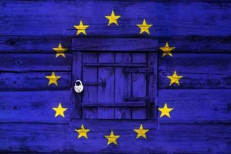 Locked europe, padlock on a closed old wooden door painted with the flag of the European Union, selected focusの写真素材