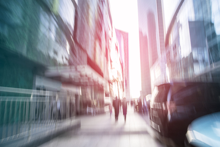 Blurred people walking through a city streetの写真素材
