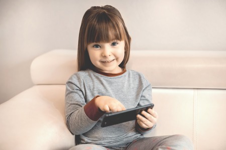 little girl using smart phoneの写真素材