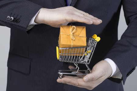 Shopping cart in businessman hand with clipping pathの写真素材