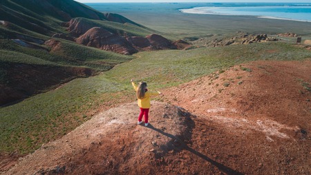 Little girl rejoices life. Natural landscape from the height of the quadcopter flight.の写真素材