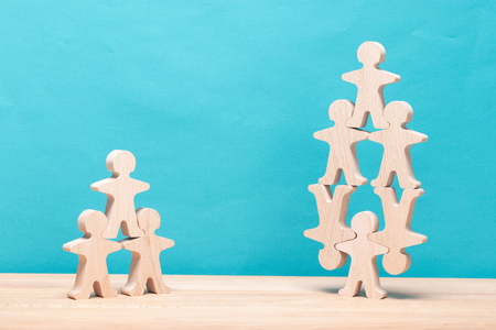 Several wooden figures in different situations. Teamwork concept. Brainstorm. New ideas. Non-standard approach to solving problems.の写真素材