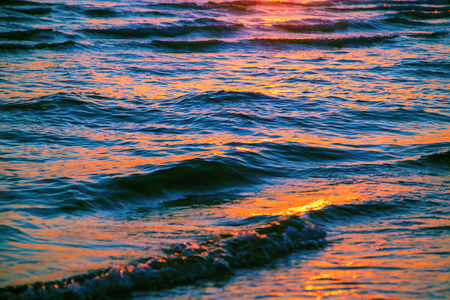 sea wave close up at sunset, low angle viewの写真素材