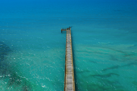Top down view of pier in turquoise water.の写真素材