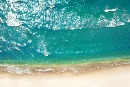 Beach and waves from top view. Turquoise water background from top view. Summer seascape from air. Top view from drone. Travel concept and ideaの写真素材
