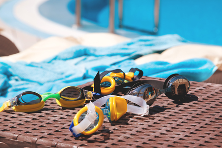 Goggles for swimming near the pool. The concept of swimming lessons for children.の写真素材