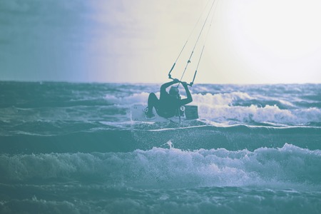 Silhouette of a kitesurfer with a kiteの写真素材
