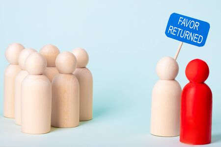 Wooden figures with the text Favor returnedの写真素材