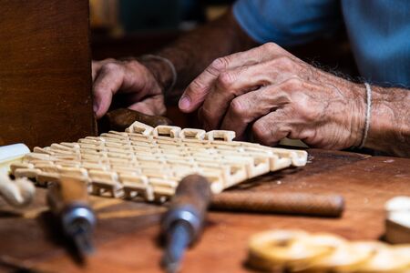 Carpenter with chisel in the hands on the workbenchの写真素材