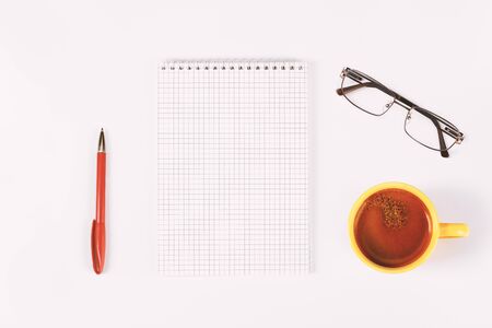 Blank diary, pen, cup of coffee and glasses on white table, mock upの写真素材