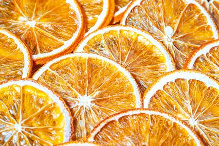Dried orange slices chips background. Dehydrated crispy fruit slices.の写真素材